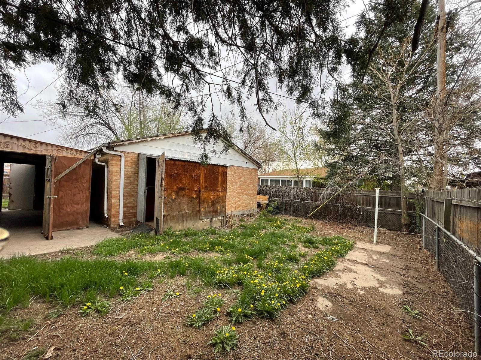 7190 Beach Street Westminster, CO 80030 - Photo 19 of 19 a backyard of a house with plants and large tree