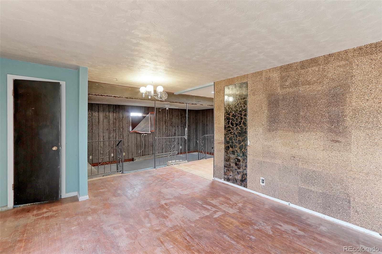 7190 Beach Street Westminster, CO 80030 - Photo 4 of 19 a view of a room with wooden floor and a bathroom