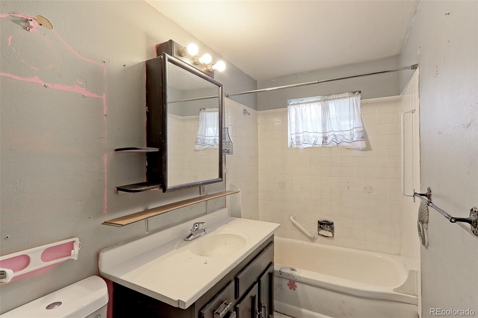 7190 Beach Street Westminster, CO 80030 - Photo 8 of 19 a bathroom with a sink toilet and shower