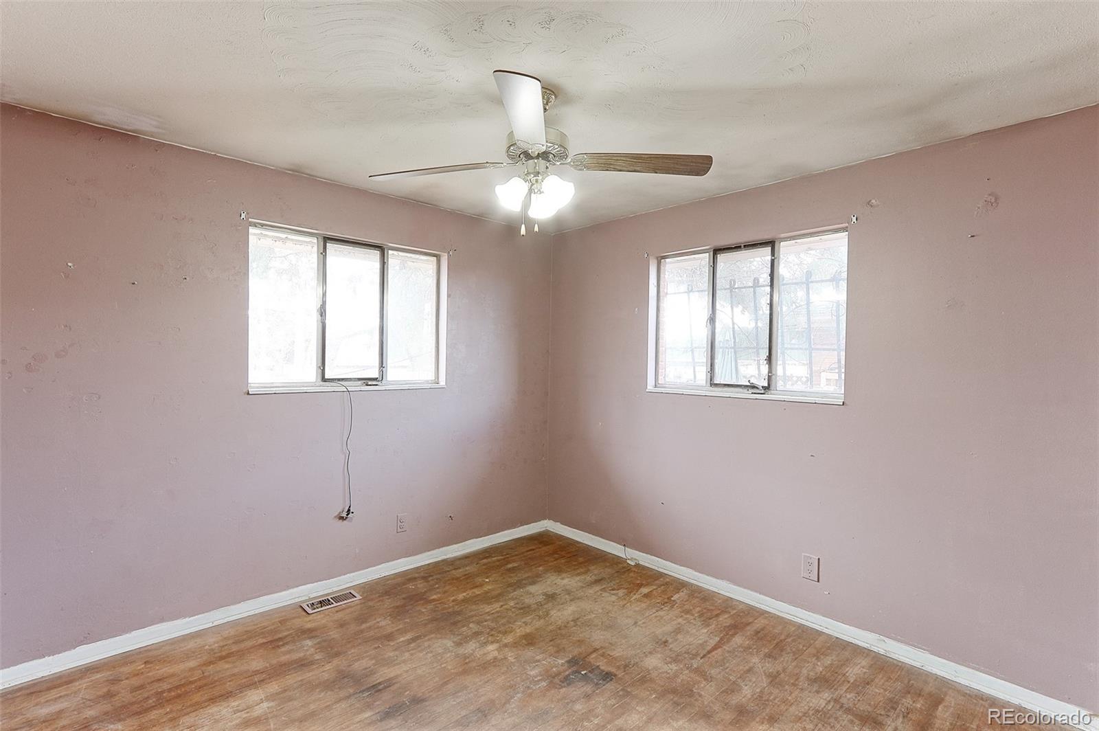 7190 Beach Street Westminster, CO 80030 - Photo 10 of 19 an empty room with windows and fan