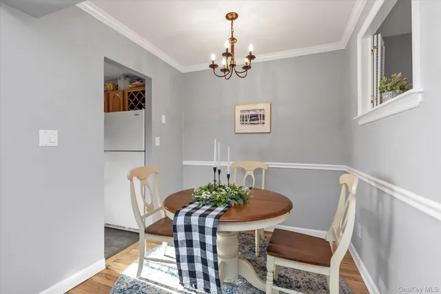 a view of a dining room with furniture and chandelier