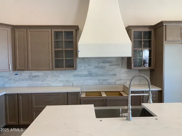 a kitchen with stainless steel appliances kitchen island sink refrigerator and stove