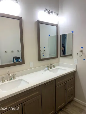 a bathroom with double sink and a mirror