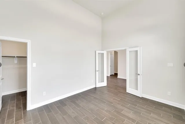 a view of an empty room with wooden floor