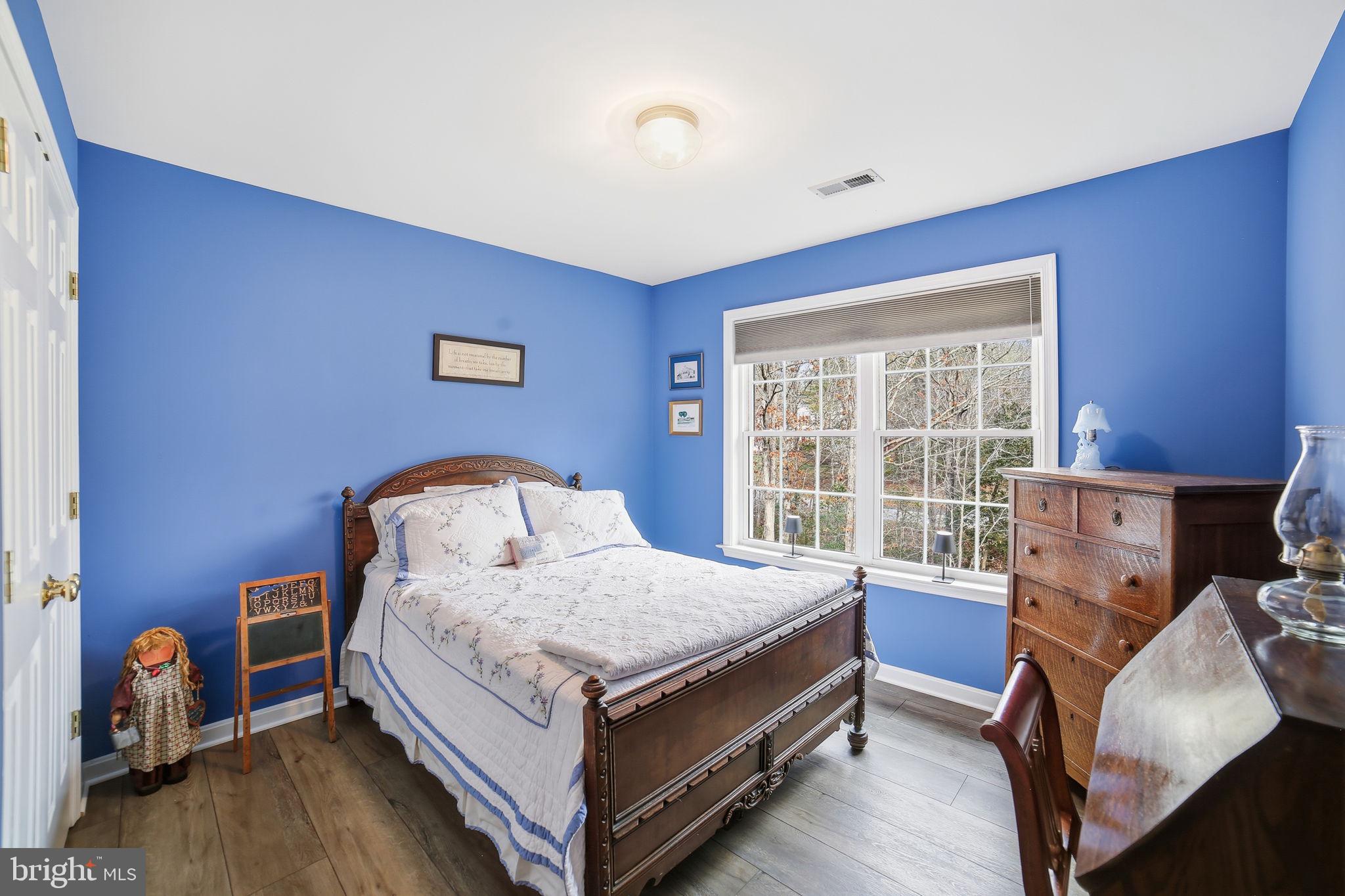 7730 Riparian Court Fredericksburg, VA 22408 - Photo 16 of 24 a bed sitting in a room next to a window