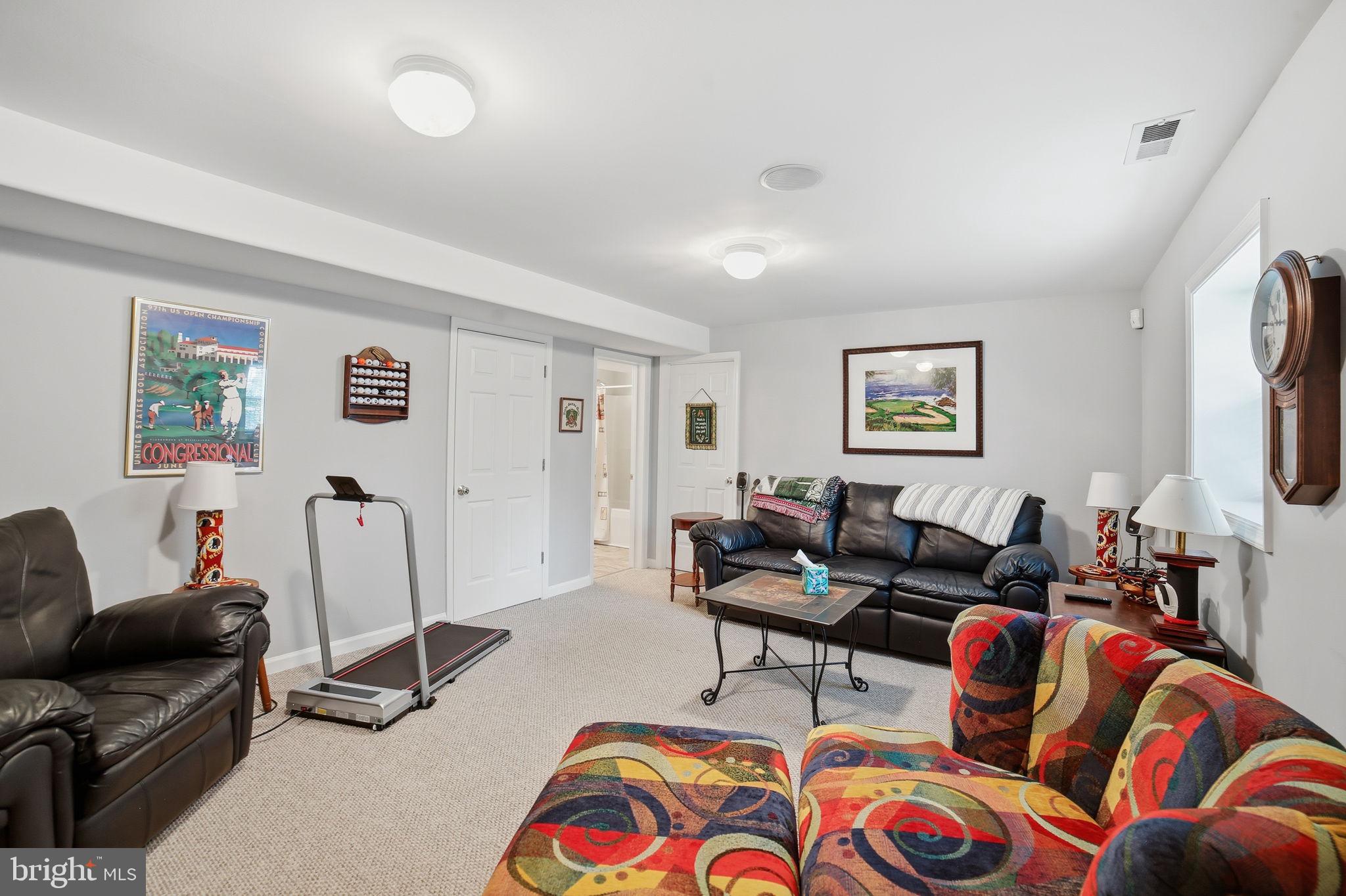 7730 Riparian Court Fredericksburg, VA 22408 - Photo 18 of 24 a living room with furniture and a flat screen tv