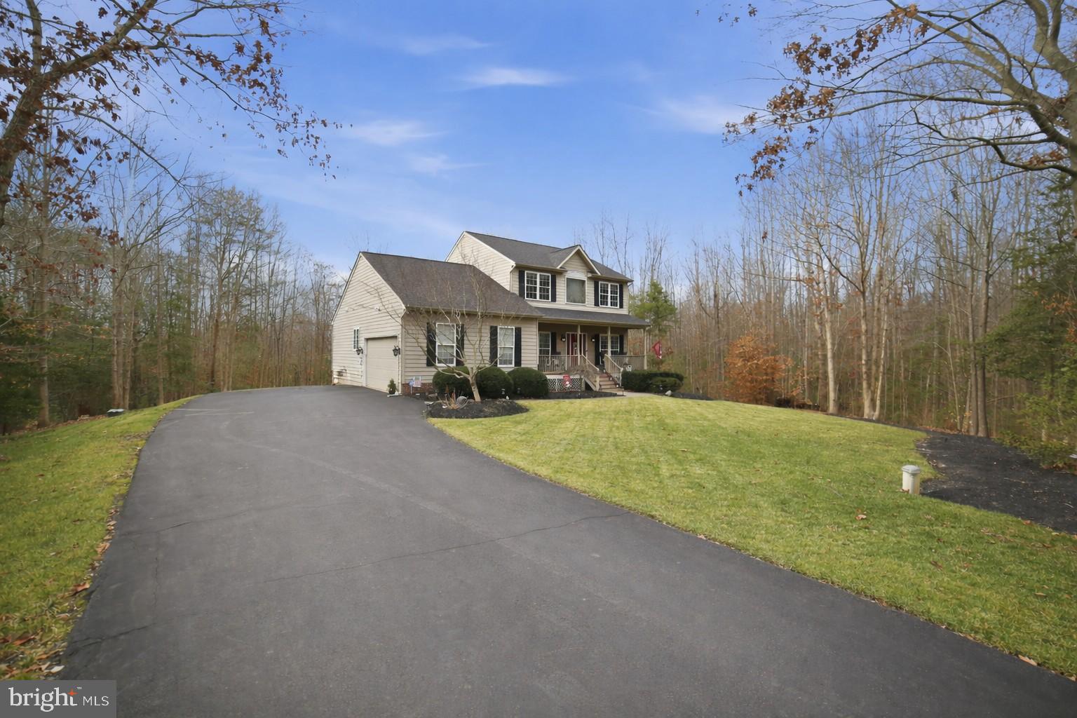 7730 Riparian Court Fredericksburg, VA 22408 - Photo 2 of 24 a front view of a house with a yard