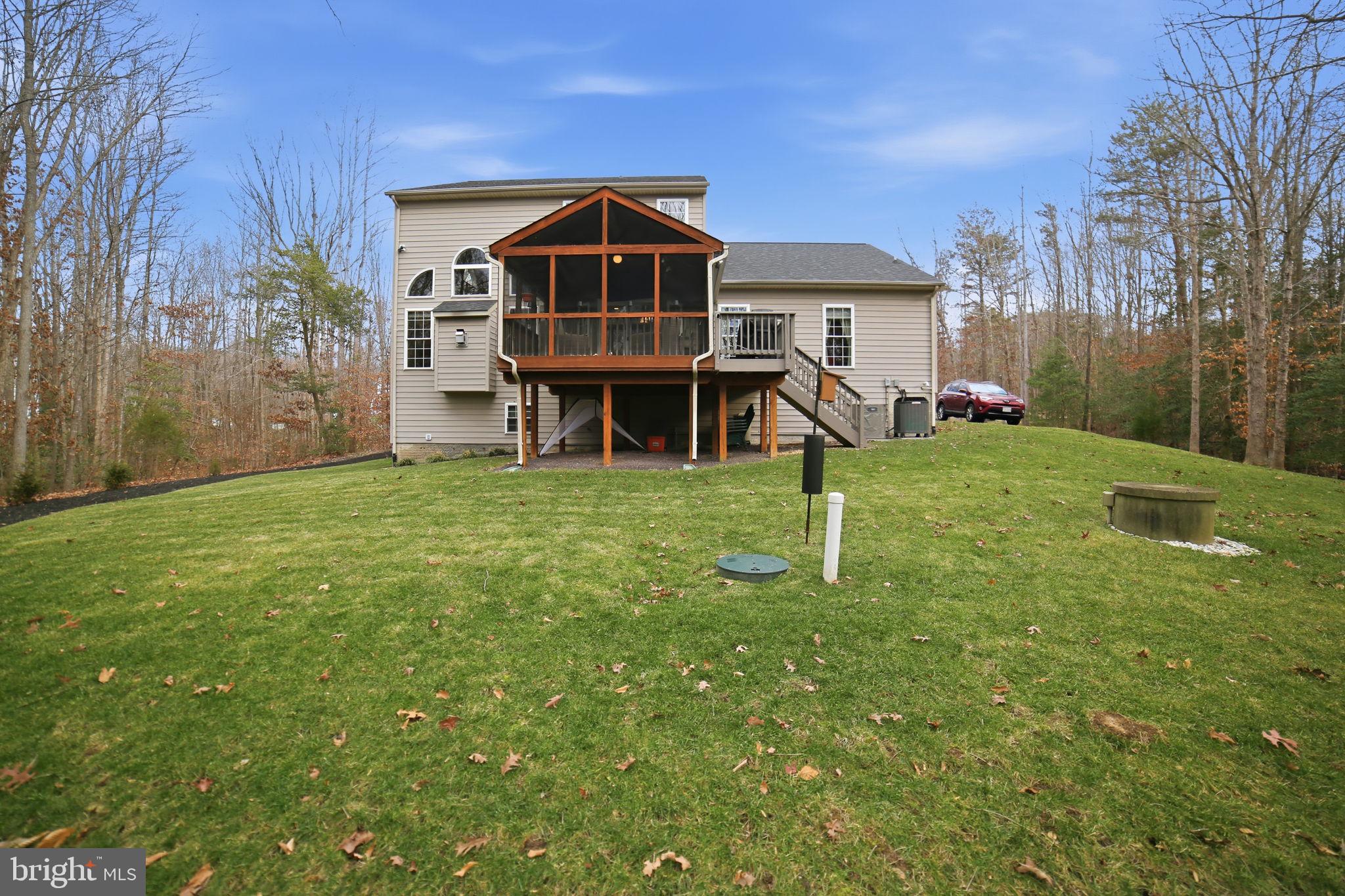 7730 Riparian Court Fredericksburg, VA 22408 - Photo 22 of 24 a front view of a house with a yard