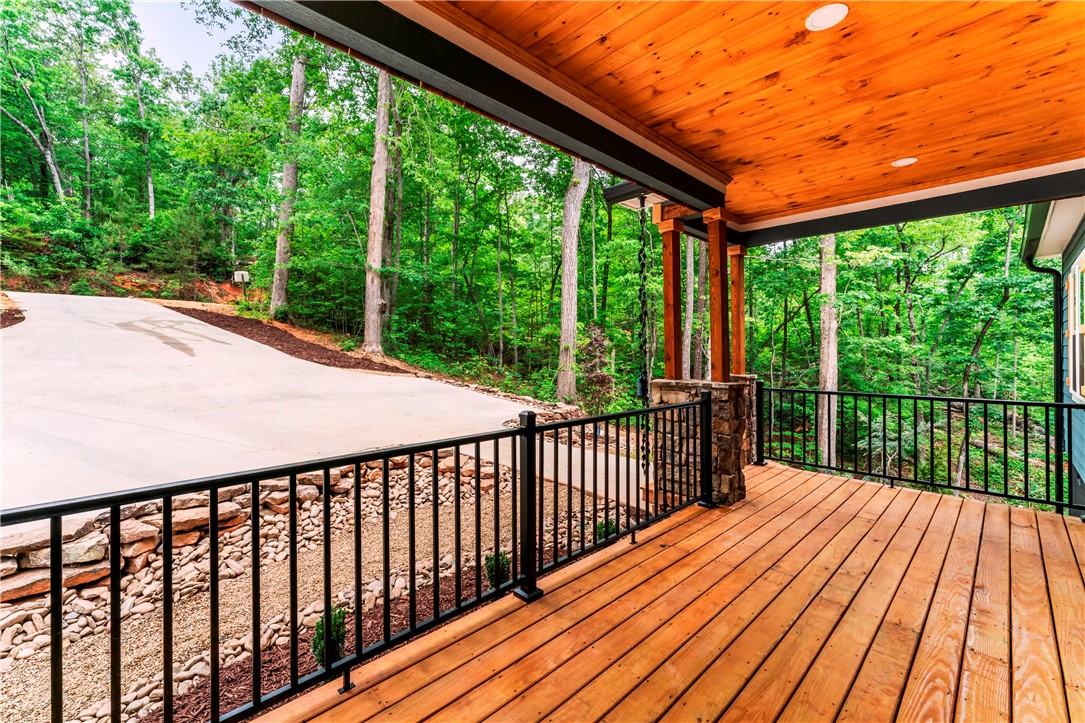 110 Gabriel Way Pickens, SC 29671 - Photo 33 of 48 A tranquil wood-planked porch, perfect for observing the serene, tree-lined landscape.