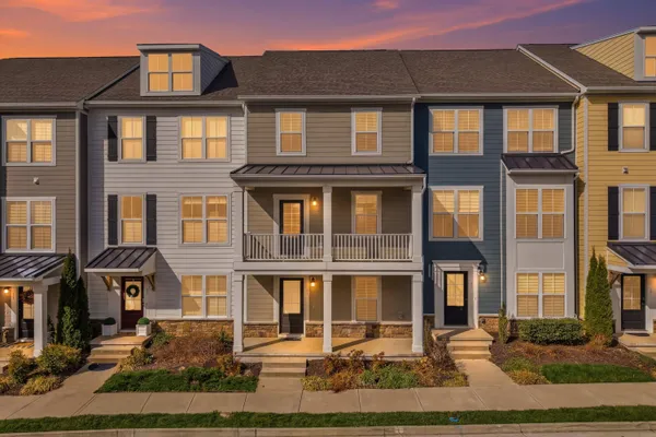 a front view of a residential apartment building with a yard