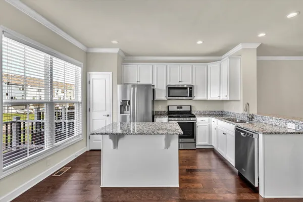a kitchen with stainless steel appliances a sink and granite counter tops