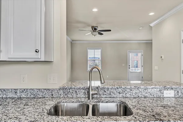 a kitchen with a sink stove and cabinets