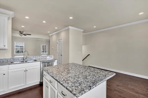 a kitchen with stainless steel appliances white cabinets and a stove top oven