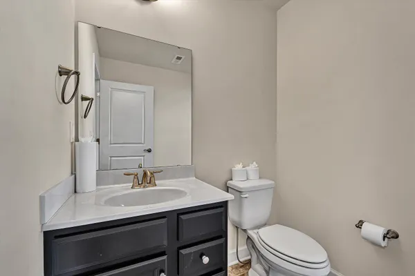 a bathroom with a sink a toilet and a mirror