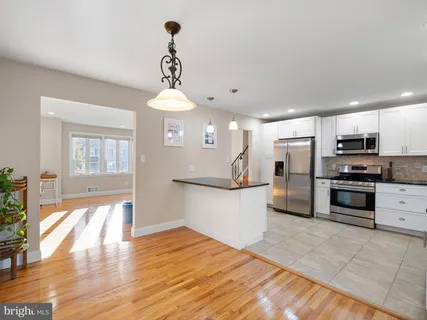 a kitchen with stainless steel appliances a refrigerator sink and microwave