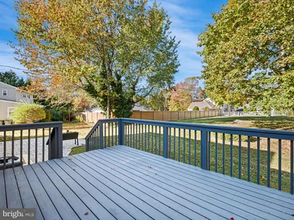 a balcony with wooden floor and fence