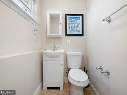 a white toilet sitting next to a bathroom sink