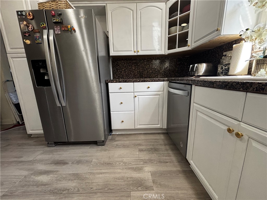 5604 Tower Road Riverside, CA 92506 - Photo 18 of 70 a view of a kitchen with refrigerator and white cabinets
