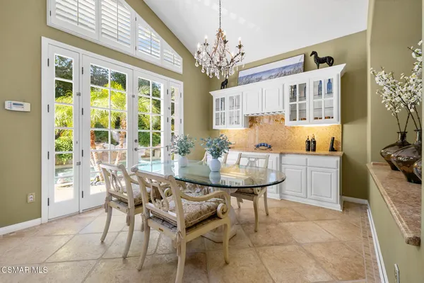 a view of a dining room with furniture and a chandelier