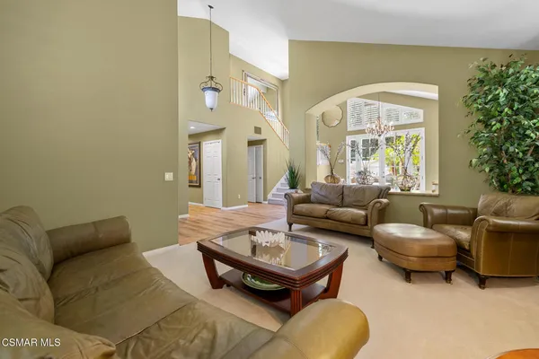 a living room with furniture and a large mirror