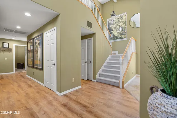 a view of entryway and hall with wooden floor