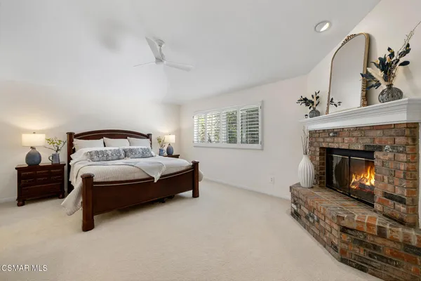 a bedroom with a bed and a fireplace