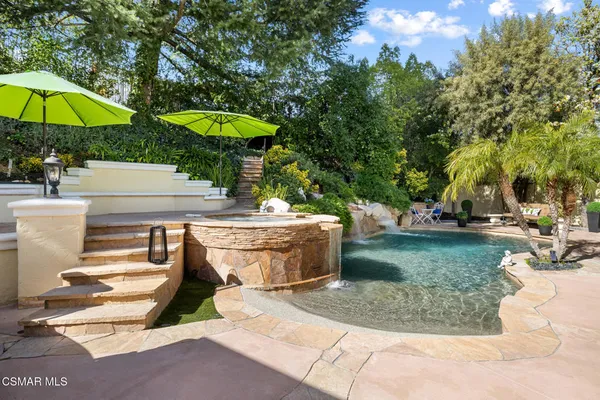 a view of a swimming pool with a patio