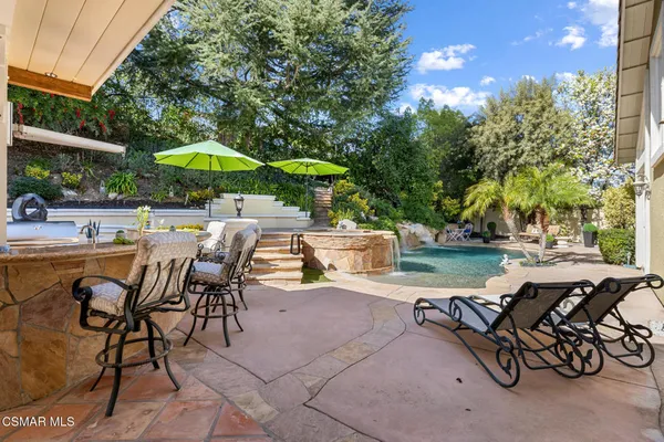 a view of backyard with outdoor seating a patio and plants