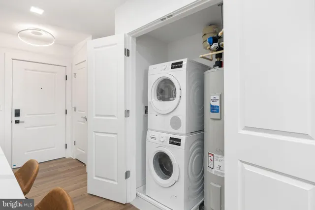 a view of a bedroom with washer and dryer