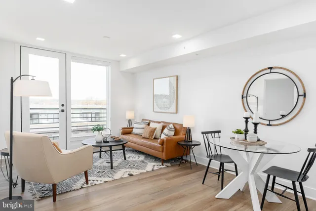 a living room with furniture a fireplace and a table