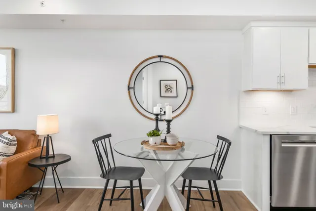a view of a dining room with furniture and a mirror