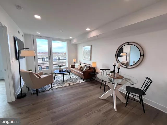 a living room with furniture a mirror and a table