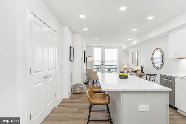 a kitchen with a table chairs and a refrigerator