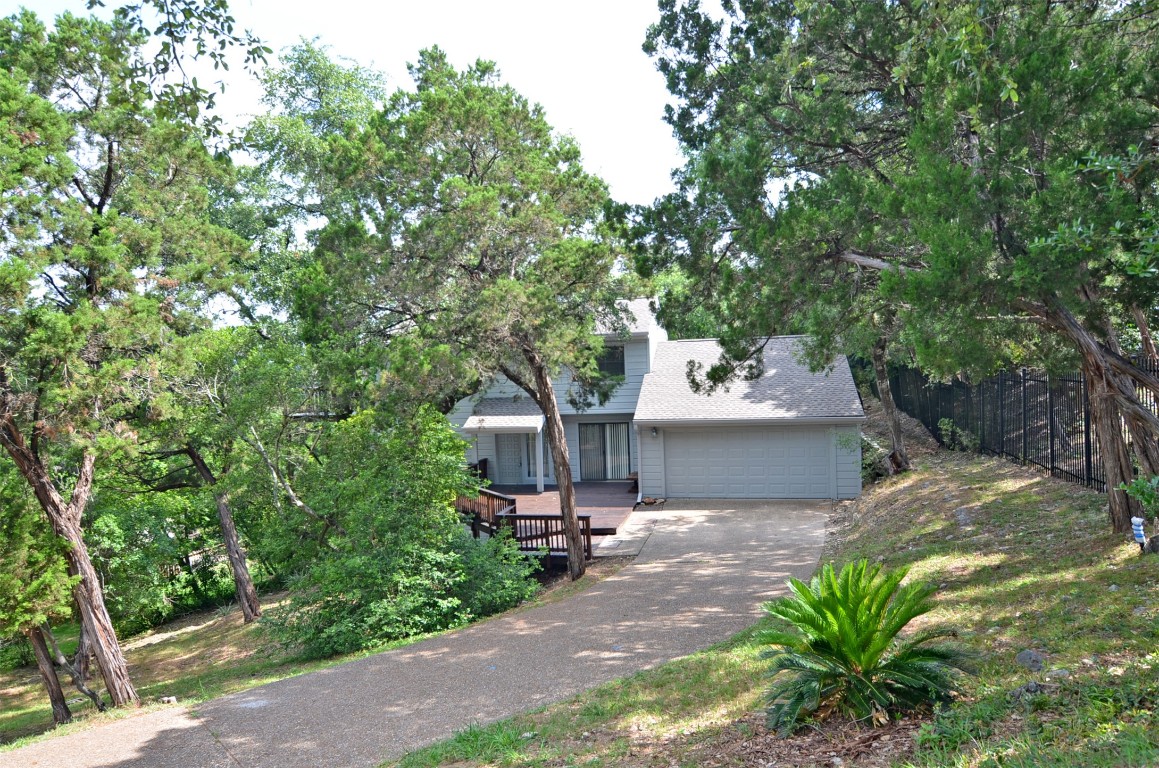 a backyard of a house with table and chairs