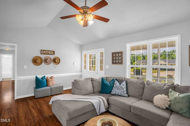 a living room with furniture and a large window