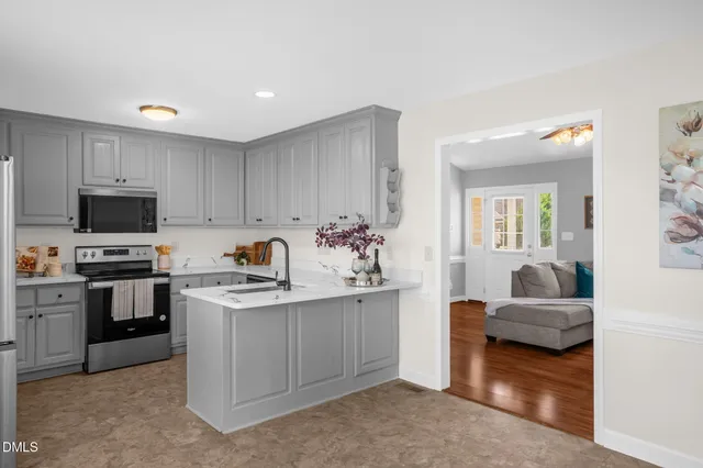 a kitchen with cabinets a sink and appliances