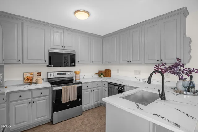 a kitchen with white cabinets and white appliances