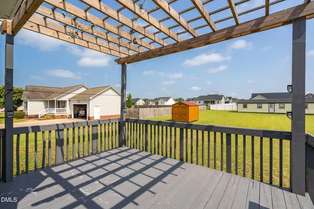 a view of a house with wooden deck