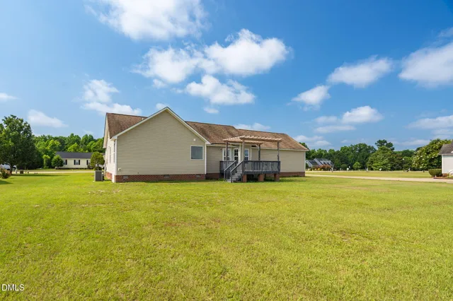 a house with huge green field in front of it