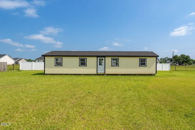 a living room with furniture a flat screen tv and a window