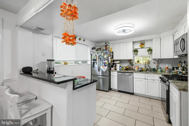 a kitchen with a sink a stove and cabinets