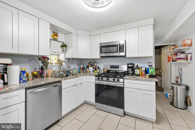 a kitchen with sink cabinets and appliances