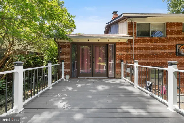 a view of backyard with small cabin and wooden fence