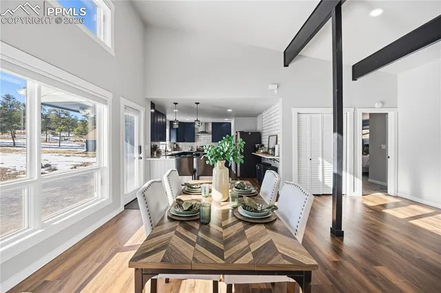 a view of a dining room with furniture window and wooden floor
