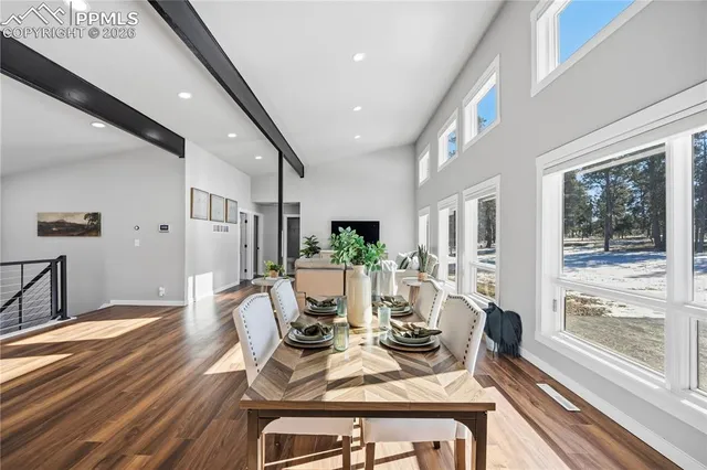 a view of a dining room with furniture window and wooden floor