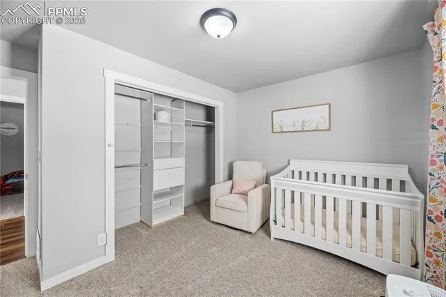 a bedroom with furniture and baby crib