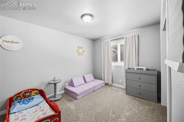 a bedroom with furniture and a window