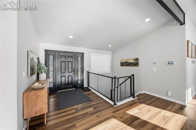 a view of a hallway with a couch and the entryway
