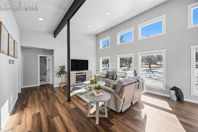 a living room with fireplace furniture and a flat screen tv