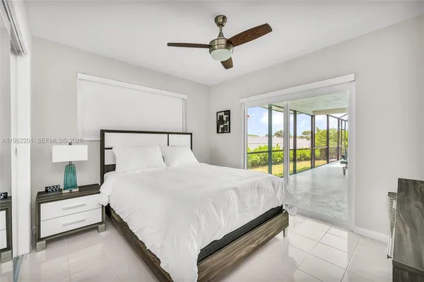 a bedroom with a bed and a large window